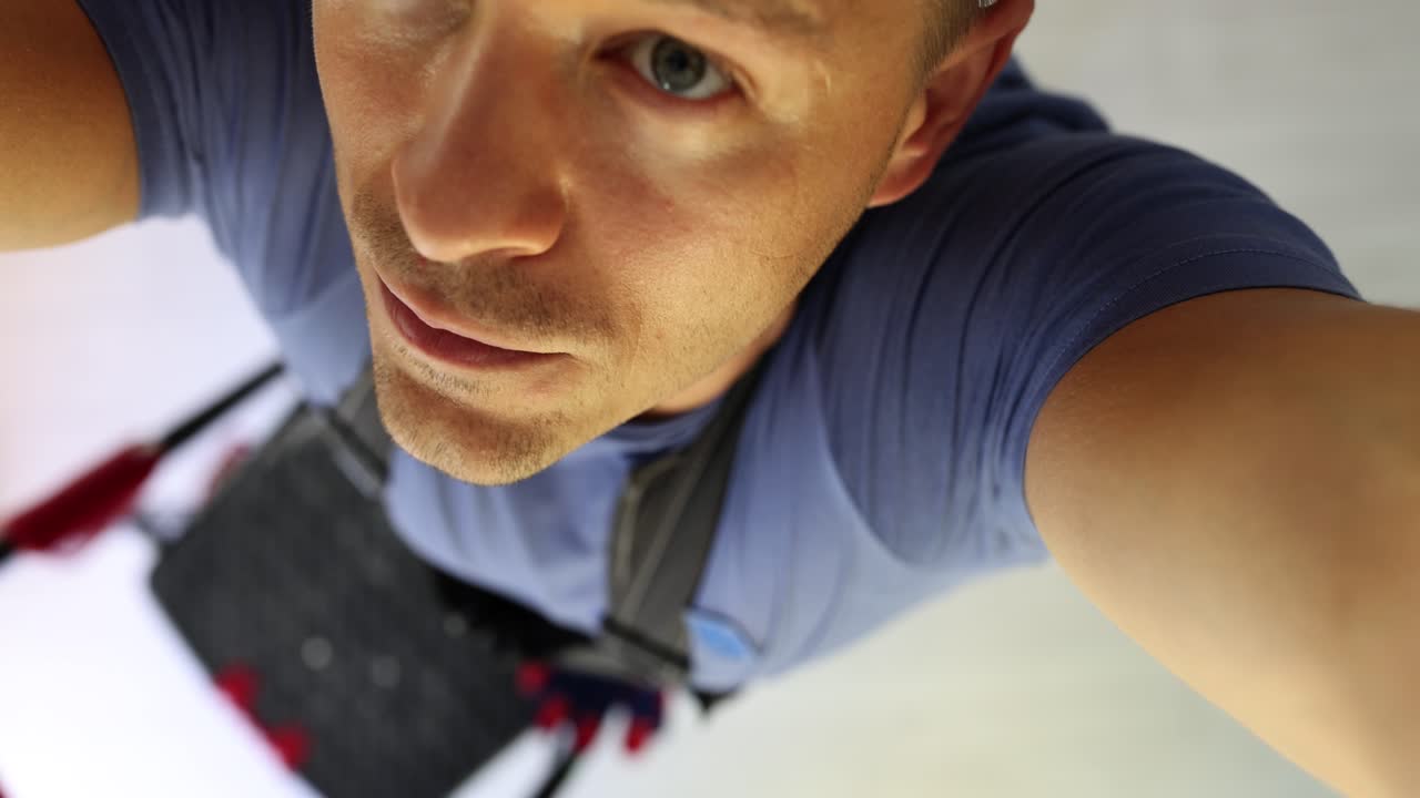 Man Looking Up from Ladder