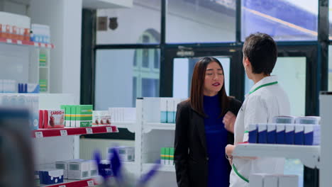 pharmacy technician assisting customer