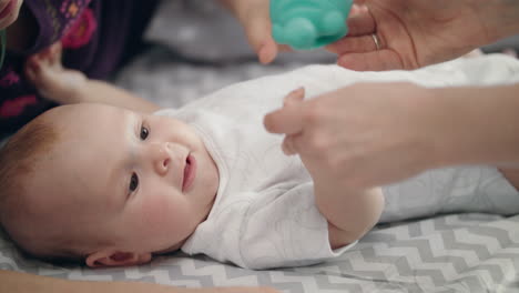 beauty child holding toy. close up of infant baby playing with mother