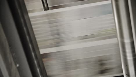 newspapers move along a conveyor belt at a newspaper factory 1