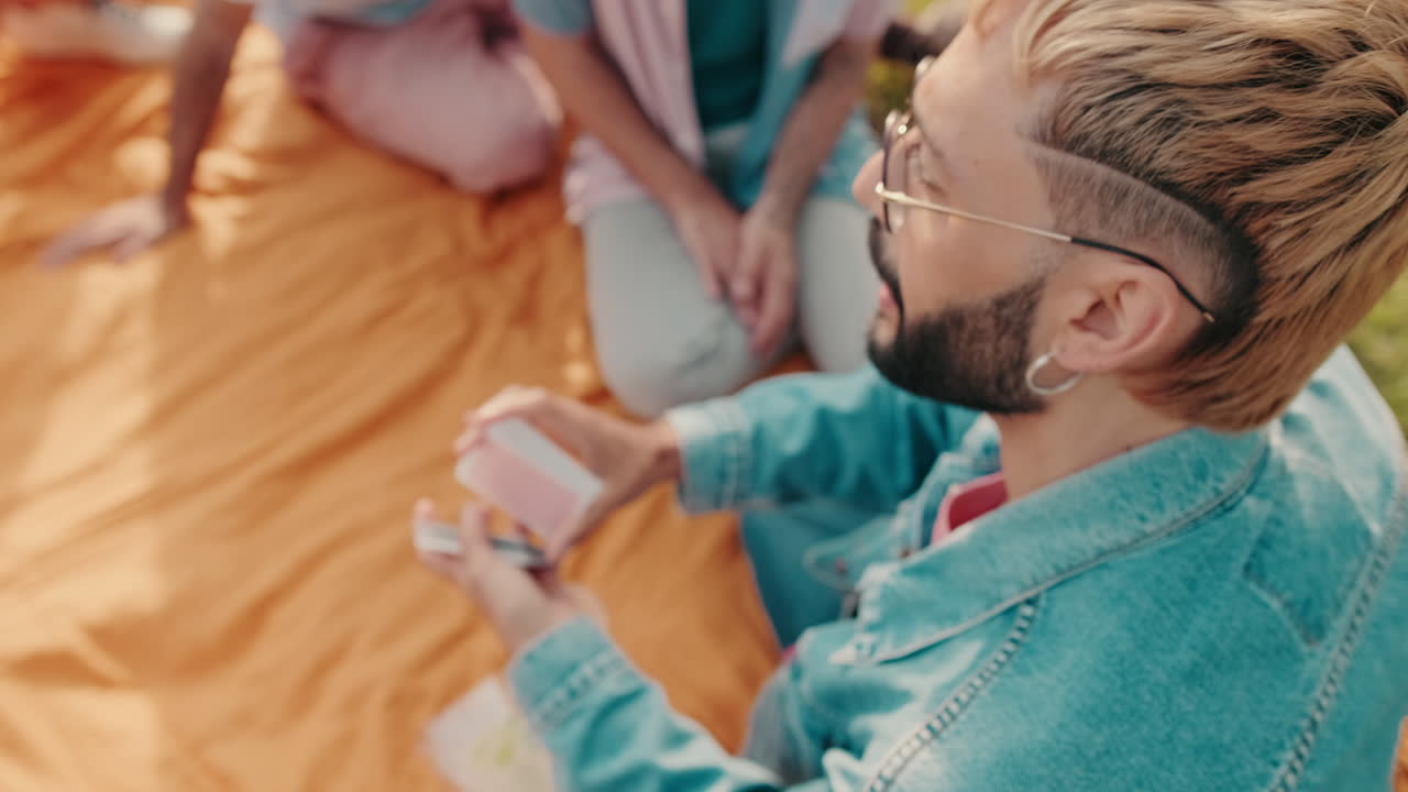 Friends Having Fun Playing Cards at a Picnic