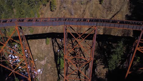 aerial panning shot over ladner creek trestle railway bridge in british columbia, canada