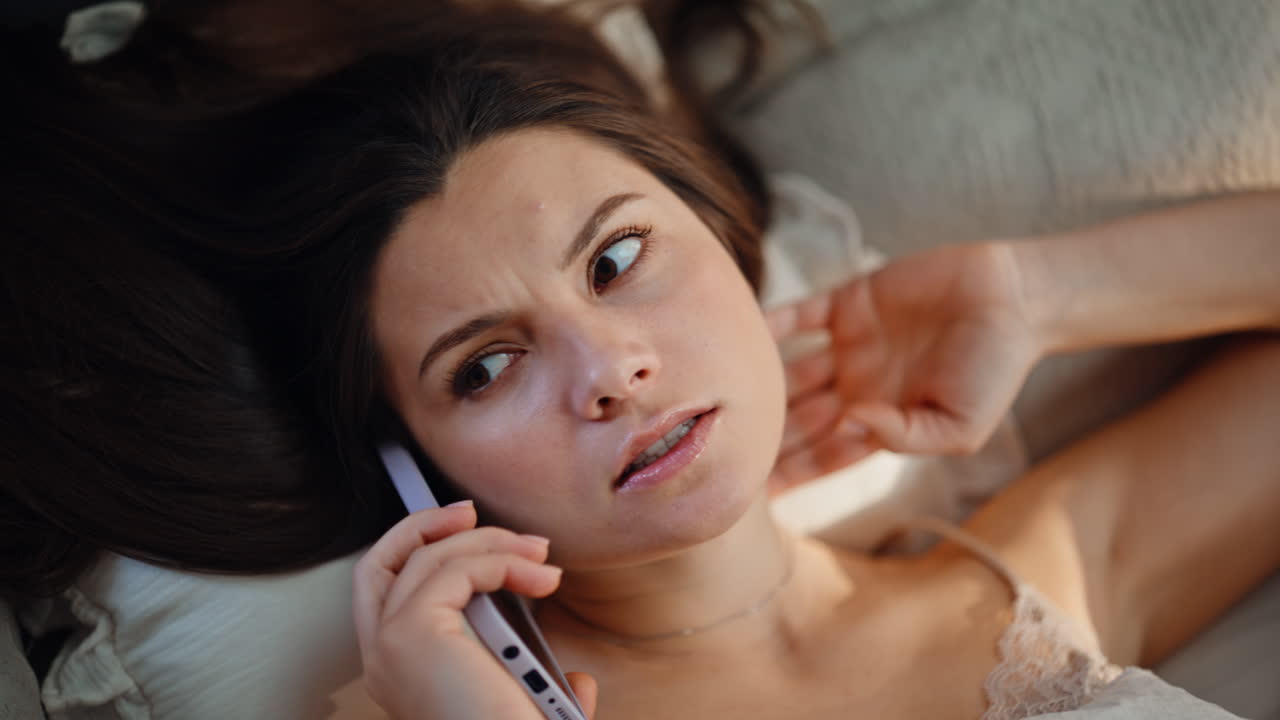 Calling woman relaxing bed enjoying cozy morning closeup. Lady talking phone
