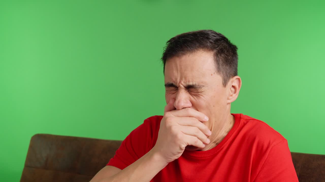 Man gets bored watching tv and starts using his phone