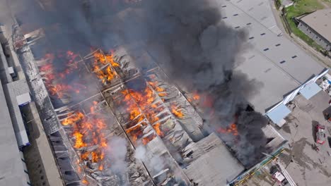 Big-Flame-And-Smoke-From-Burning-Warehouse-In-Santo-Domingo,-Dominican-Republic---Aerial-Drone-Shot