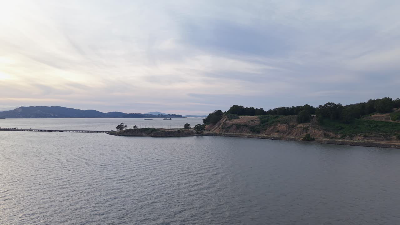 Elevated drone view of Point Molate showcases the gentle curve of shoreline and the calm waters beyond.