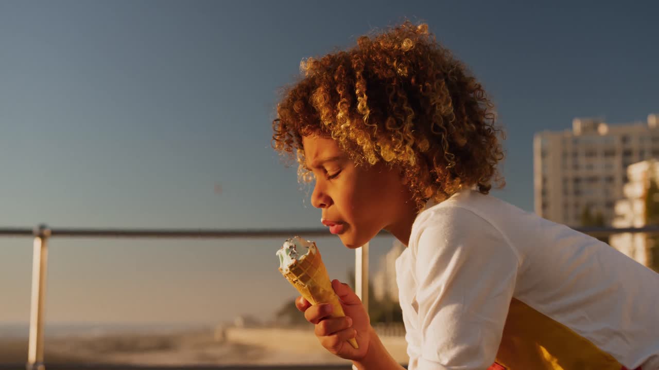 Little boy eating ice cream at sunset