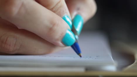 woman hand writing with pen close up