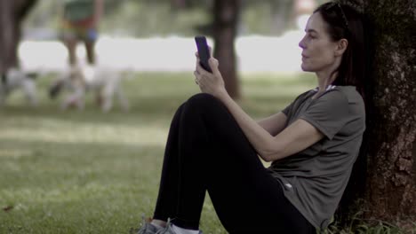 relaxing in the local park, staying connected using smartphone technology