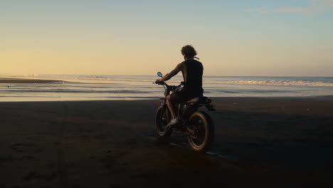 motorcycle ride on a beach at sunrise/sunset