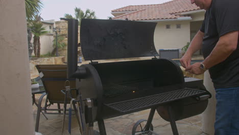 man lights match and starts fire in bbq pit next to backyard pool