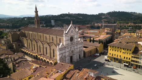 Drone-push-in-to-white-facade-of-Basilica-of-Santa-Croce-in-Florence-Italy-at-midday