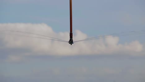 large farming equipment sprinkler against blue sky watering early morning sunrise on commercial farm