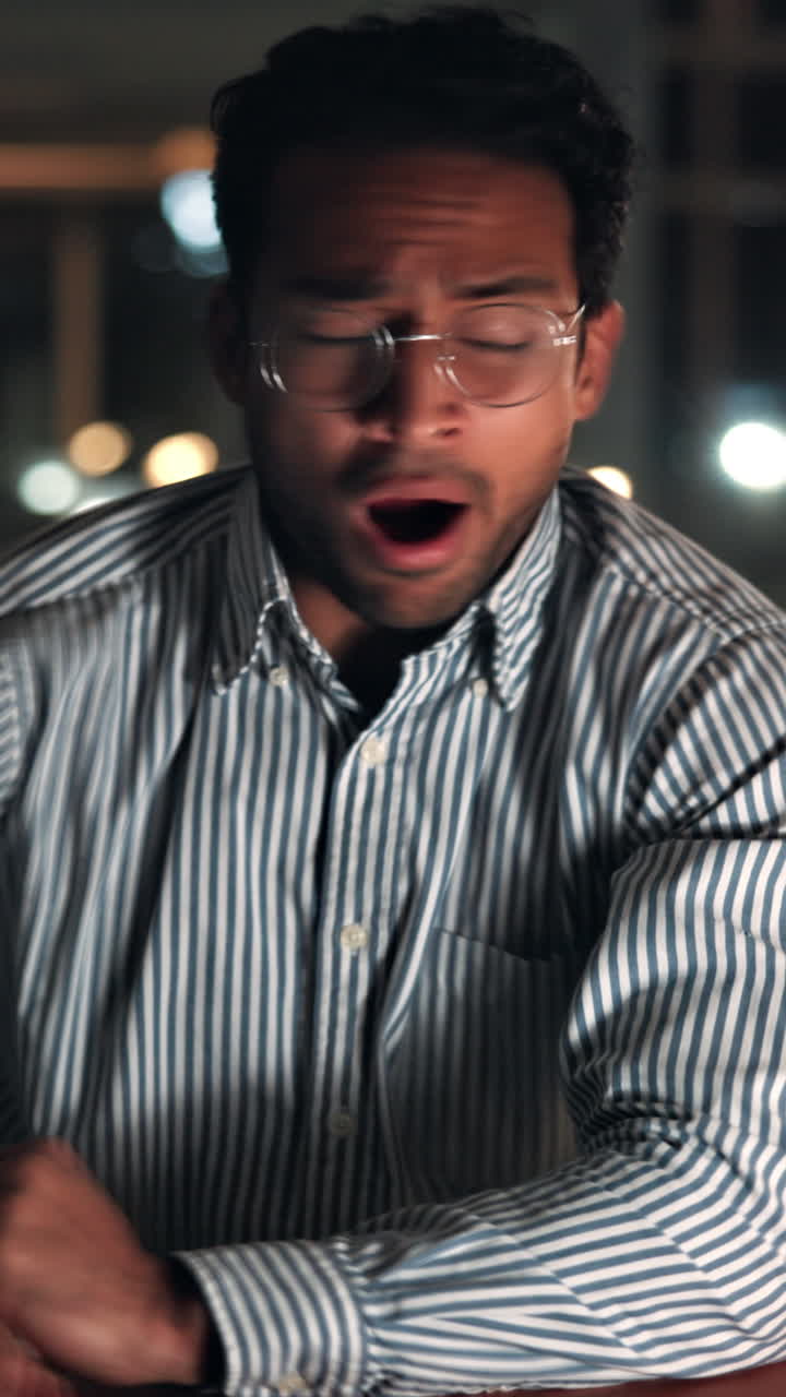 Young Man Yawning and Putting on Glasses, Feeling Tired