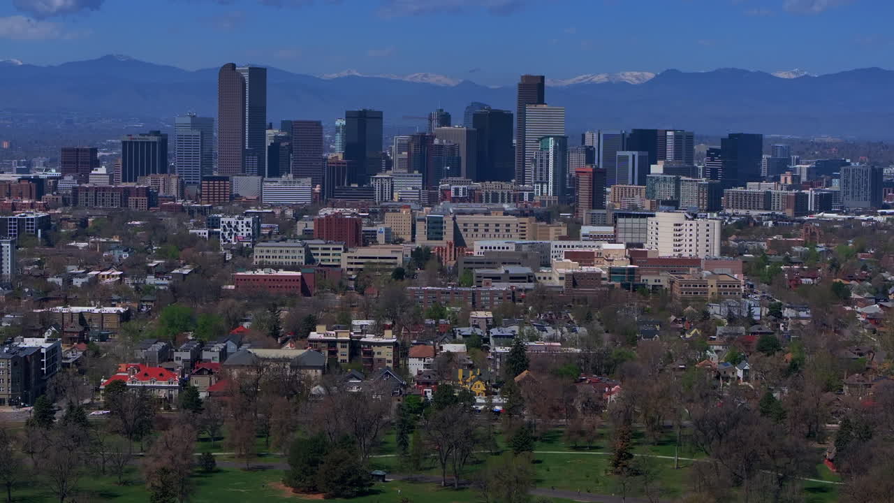 City Park Lodo Downtown Denver Cityscape Landscape Colorado aerial drone view tall skyscraper buildings neighborhood Wash Park City Park Pavilion Spring summer front range mountains upwards motion