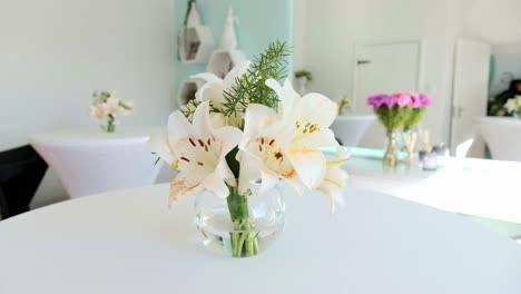 a beautiful white lily flower arrangement in a glass vase