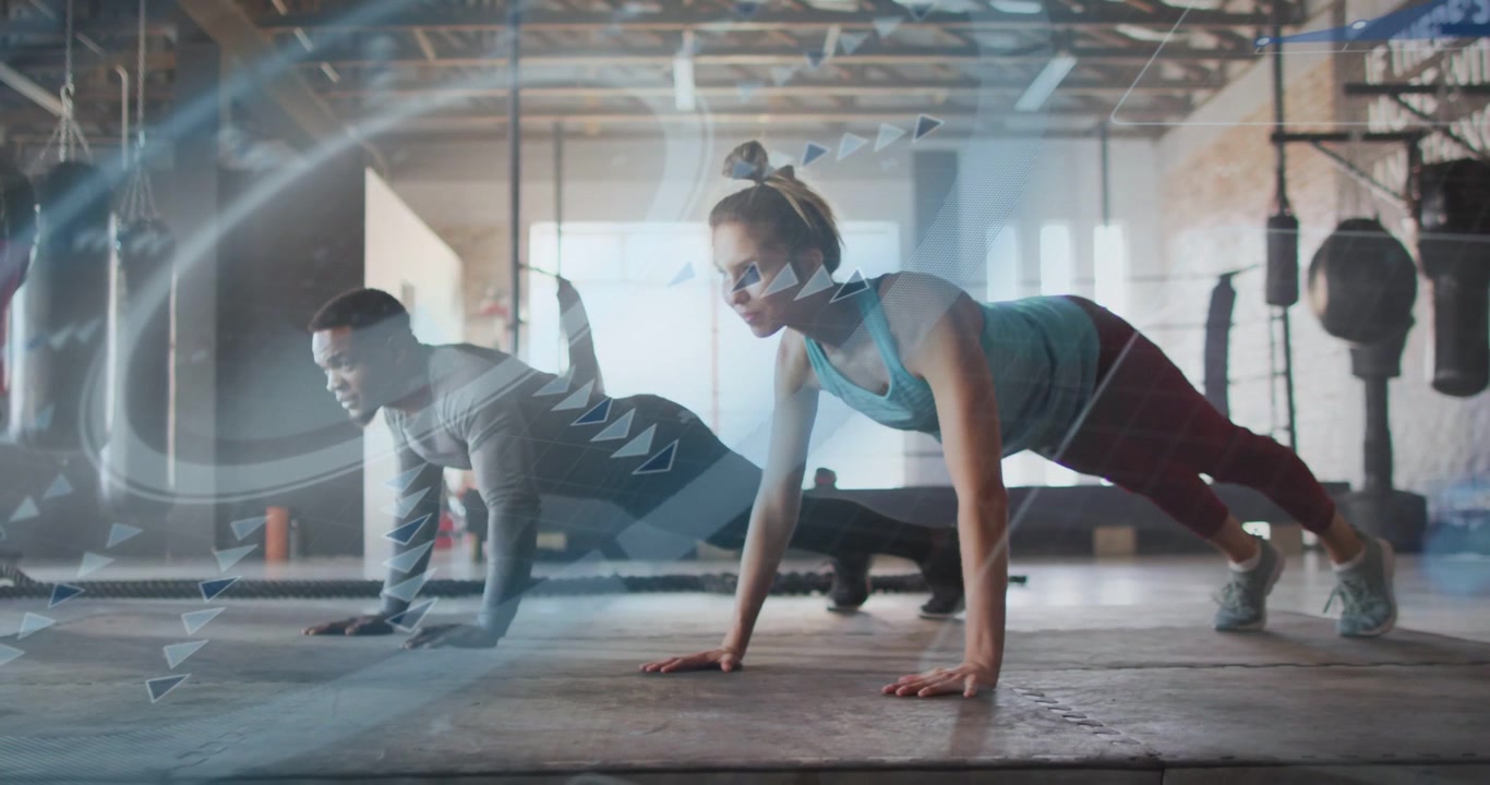 Vertical video: Following onscreen prompt pair doing push-ups in sync on gym rubber mat in gym gear