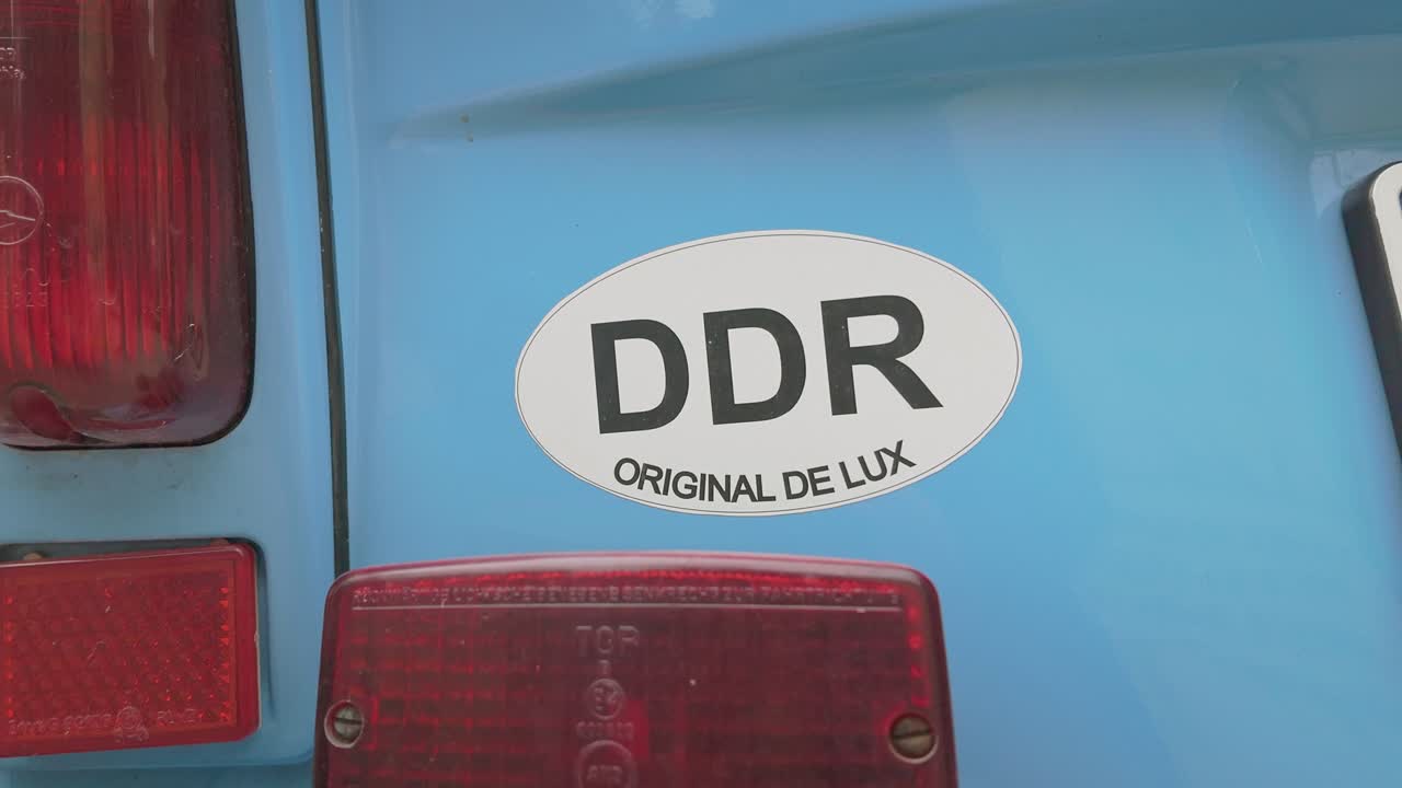 DDR sticker on rear of East German retro classic car CLOSE-UP pan shot