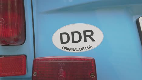ddr sticker on rear of east german retro classic car close-up pan shot