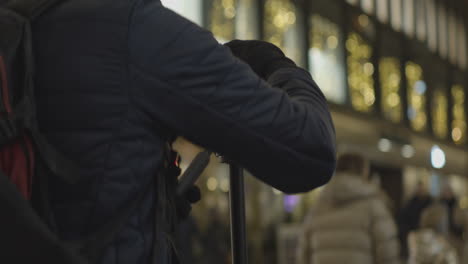 photographer adjusts a camera on a tripod to capture a central city street at night