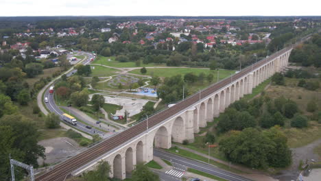 aerial drone view of the historical railway viaduct over the bobr river and skatepark in bolesławiec, lower silesia, poland