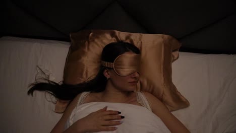 top view of a beautiful young caucasian woman sleeping in her bed any night