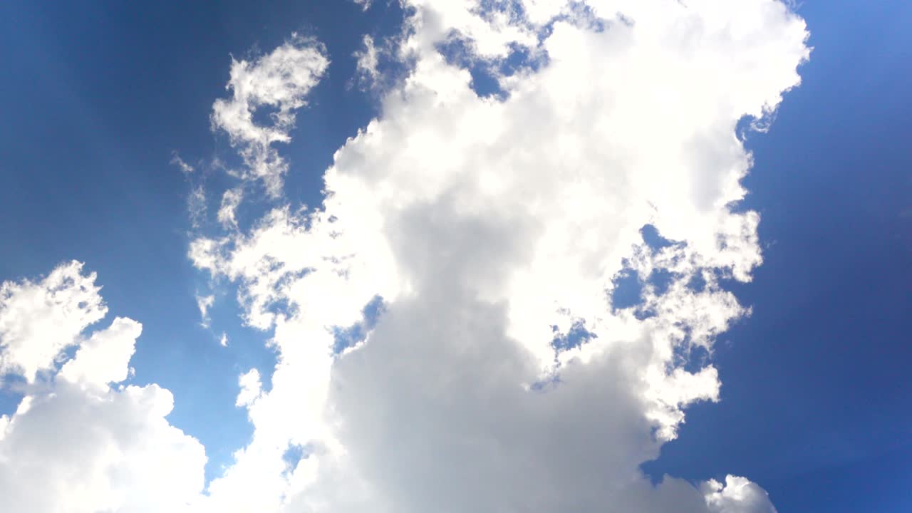 Cloudscape with bright sun shining with clouds passing