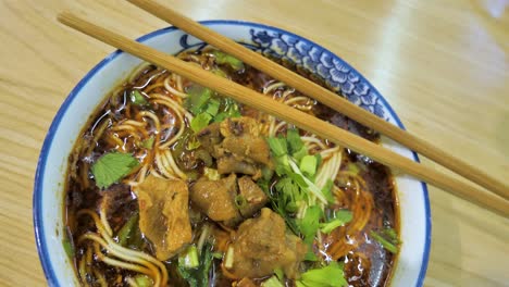 close up of delicious china food, beef noodle mi xian with braised beef slices and coriander, china