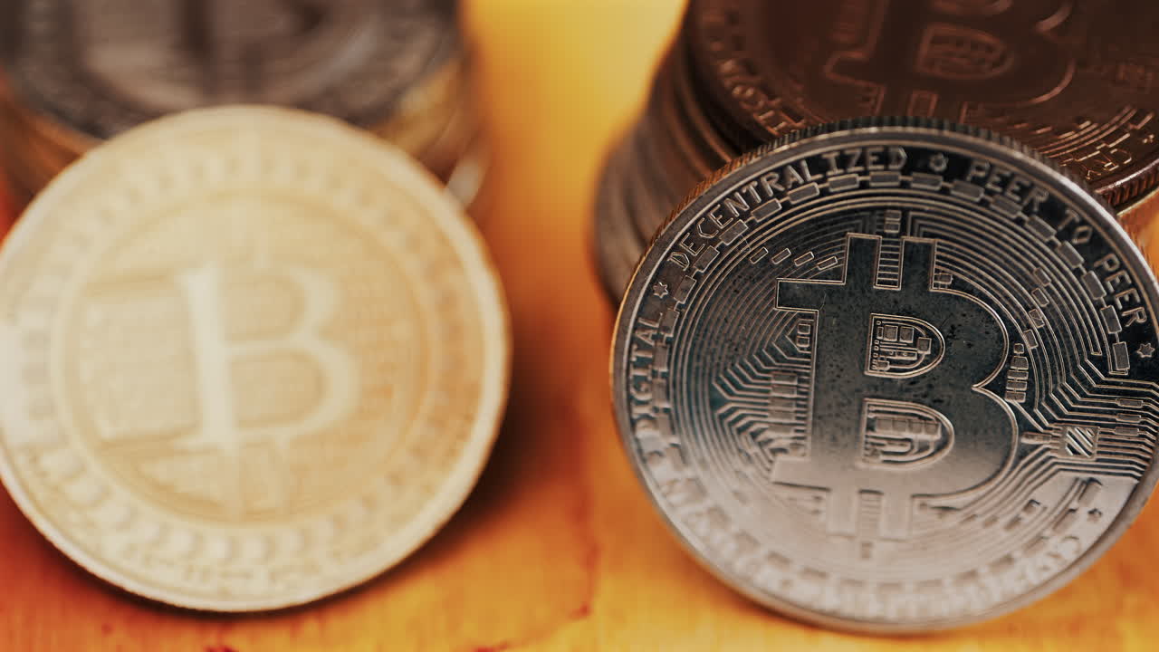 Close up of shiny physical Bitcoin coins stacked on a table