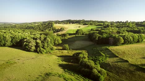 aerial view of tractor harvesting straw bales.