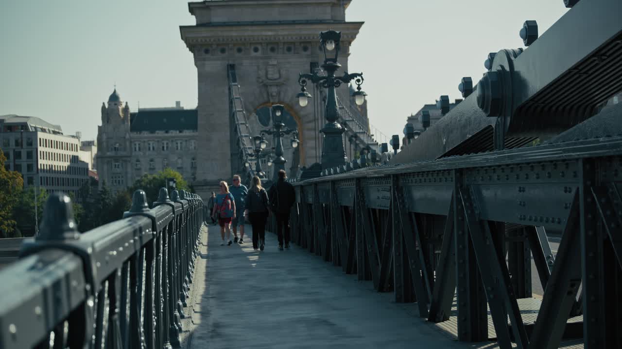 Pedestrians walking on the Széchenyi Chain Bridge, the historic suspension bridge in Budapest
