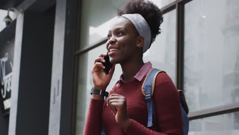 african american talking on her smartphone in street