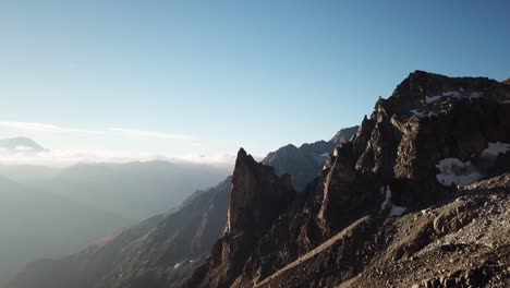 rocky steep mountains viewed by drone during a sunrise, alps, switzerland