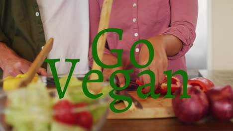 animación de texto de veganismo sobre la cocina de parejas diversas