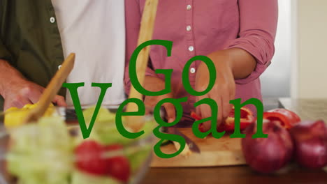 animation of go vegan text over diverse couple cooking