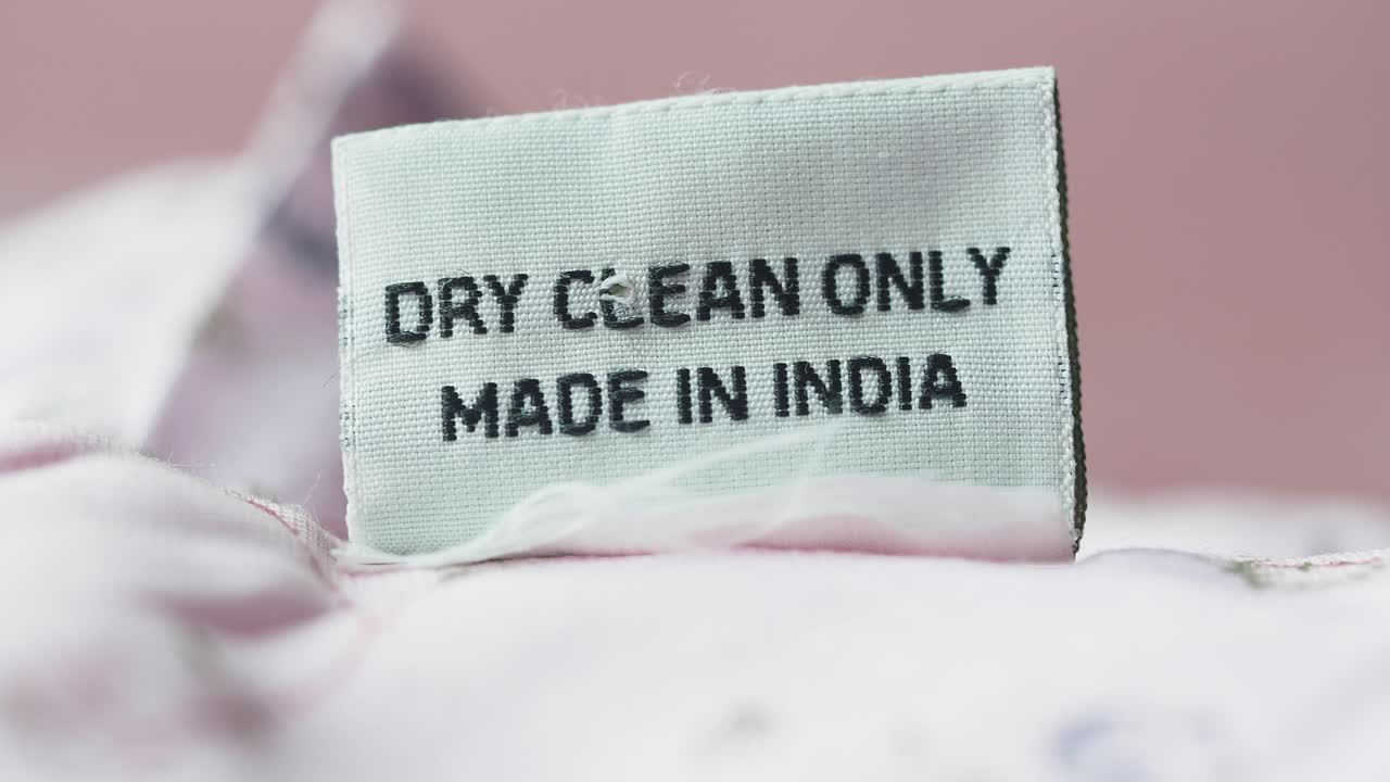 Close-up of a clothing tag with dry clean only and made in India instructions.