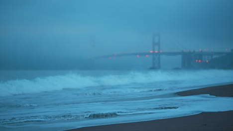 Fog-enshrouded-Golden-Gate-Bridge-viewed-from-Baker-Beach-in-San-Francisco-during-an-early-morning