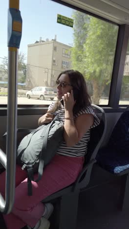 woman on bus talking on phone