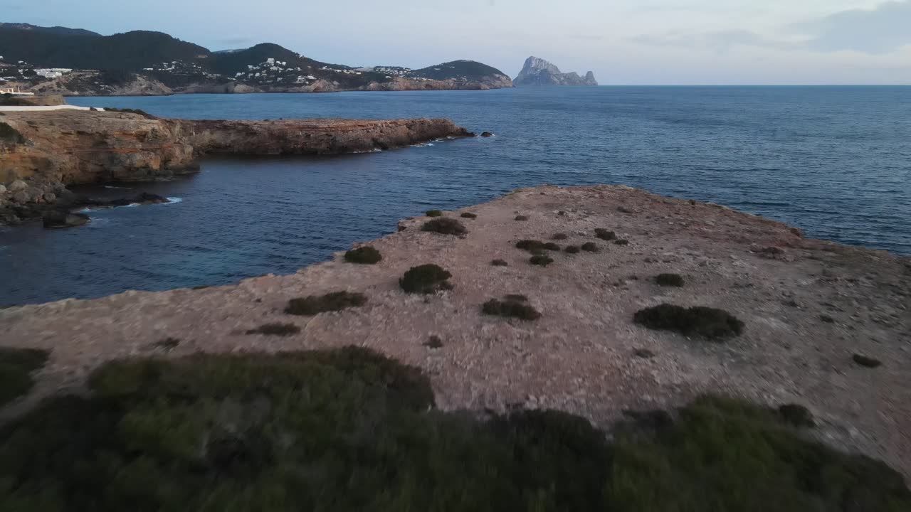 amazing aerial approach shot of the island of Es Vedrá in Ibiza
