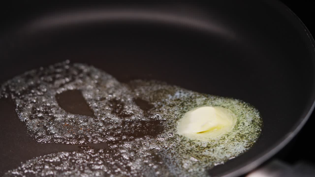 Butter melting in pan, close-up of hot surface and cooking preparation process