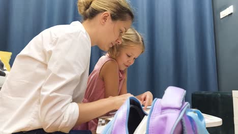 mother helping daughter with homework