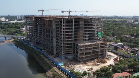 aerial shot of cooum river around the construction buildings surrounded by trees