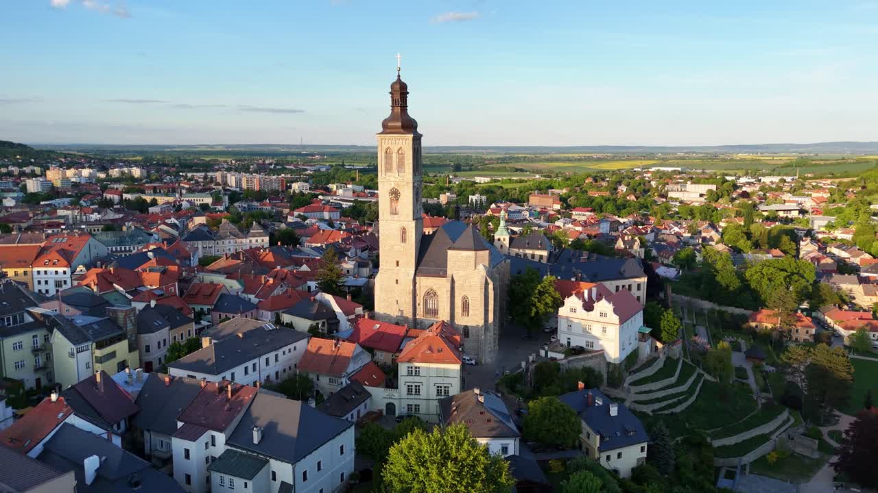 Drone footage of St. James Church rising above historic rooftops in Kutná Hora, Central Bohemia. Czech Republic