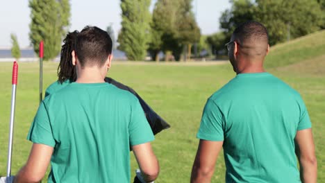 back view of happy volunteers in park