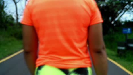 girl wearing sportswear walking front back on rural street, asunction