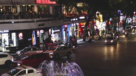 illuminated urban scene with active vehicular movement