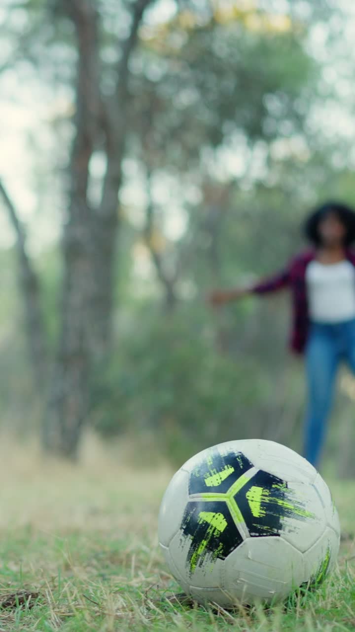 A person playing soccer in a park