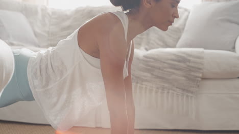 beautiful-woman-exercising-at-home-practicing-yoga-poses-in-living-room-enjoying-morning-fitness-workout-4k