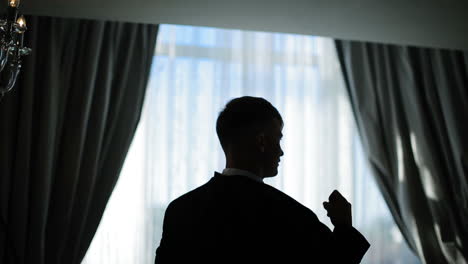 man wears a jacket. concept of business dress. successful guy dressing up for an appointment and adjusting his jacket