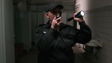 female safety guard with flashlight in a warehouse